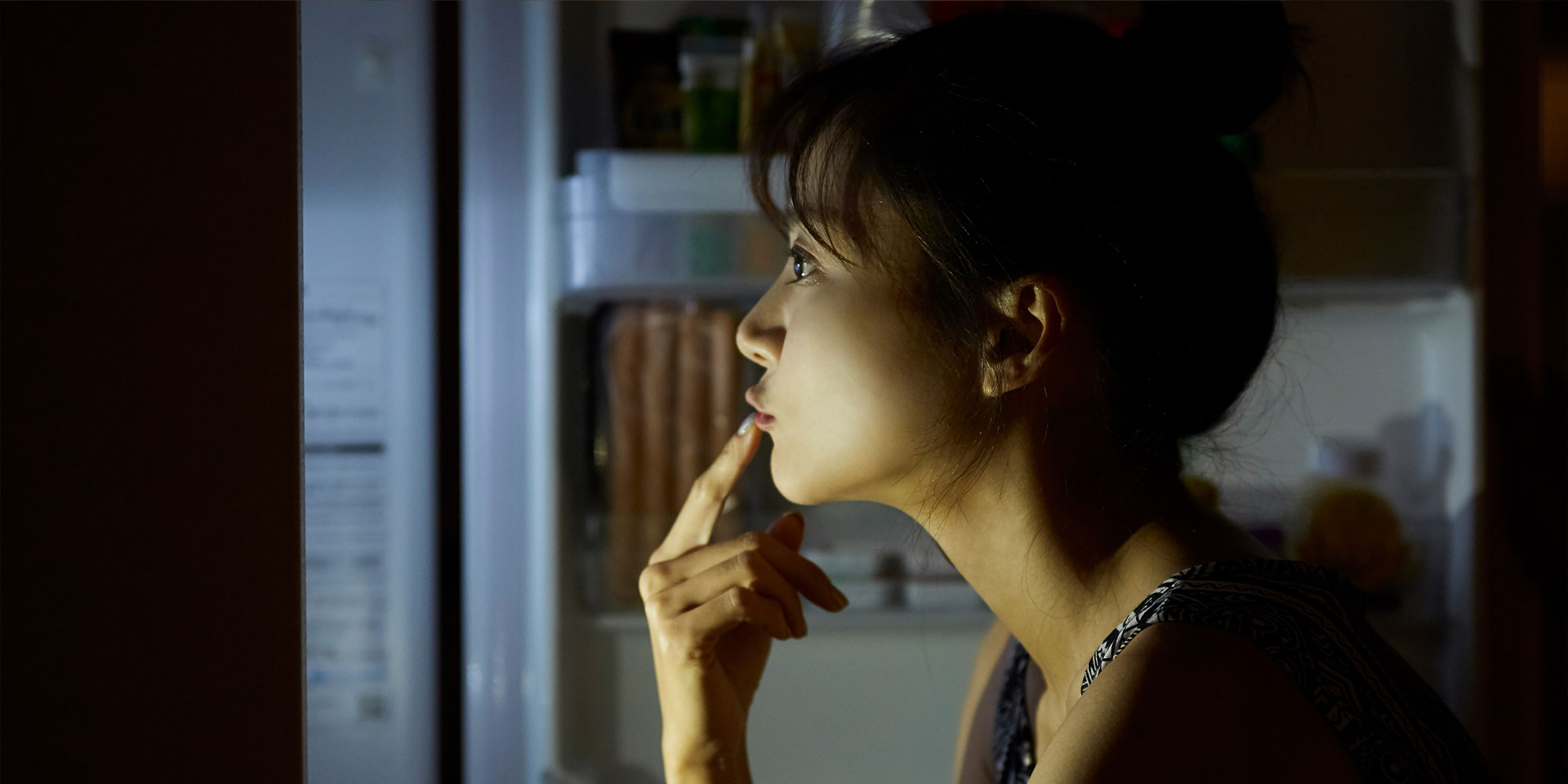 夜中に冷蔵庫を開ける女性